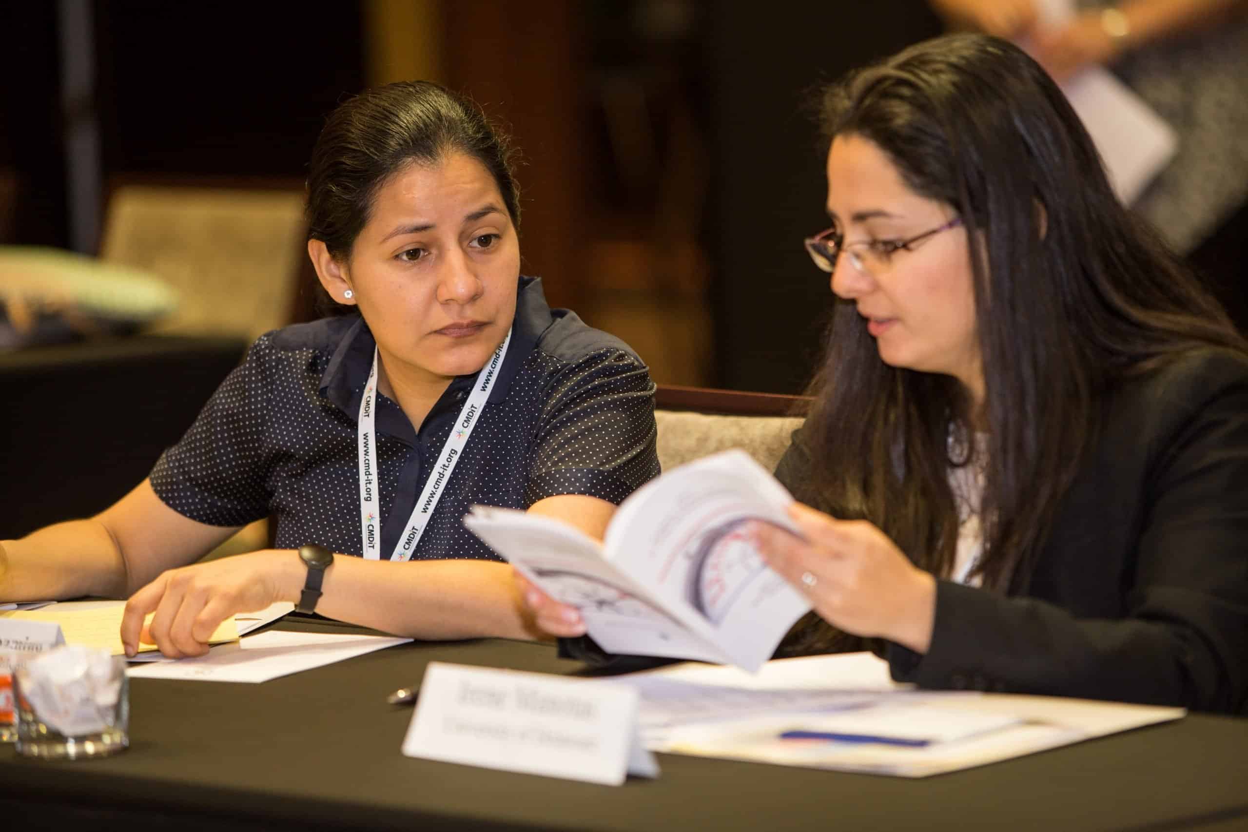 Two speakers talking at a table