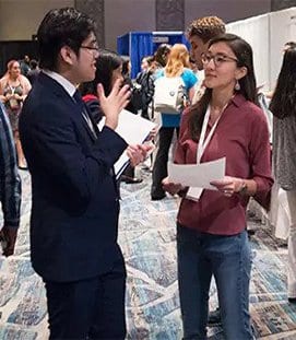 Student talking with recruiter at 2019 Tapia Career Fair