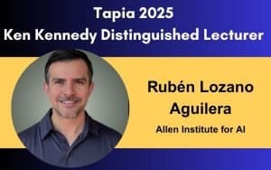 Smiling man in a collared shirt with text: "Tapia 2025 Ken Kennedy Distinguished Lecturer, Rubén Lozano Aguilera, Allen Institute for AI" on a blue and yellow background, highlighting new perspectives and diversity in AI.